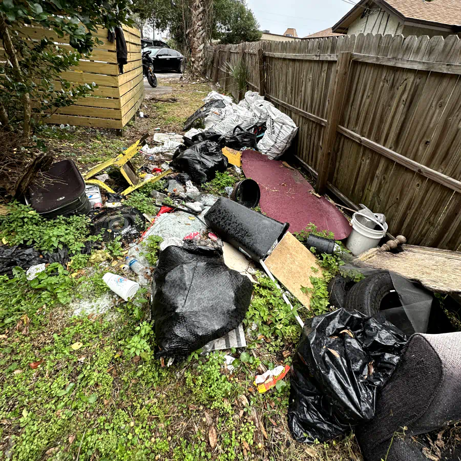 patio with grass and trash bags